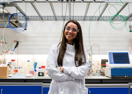 Scientist smiles in her lab.